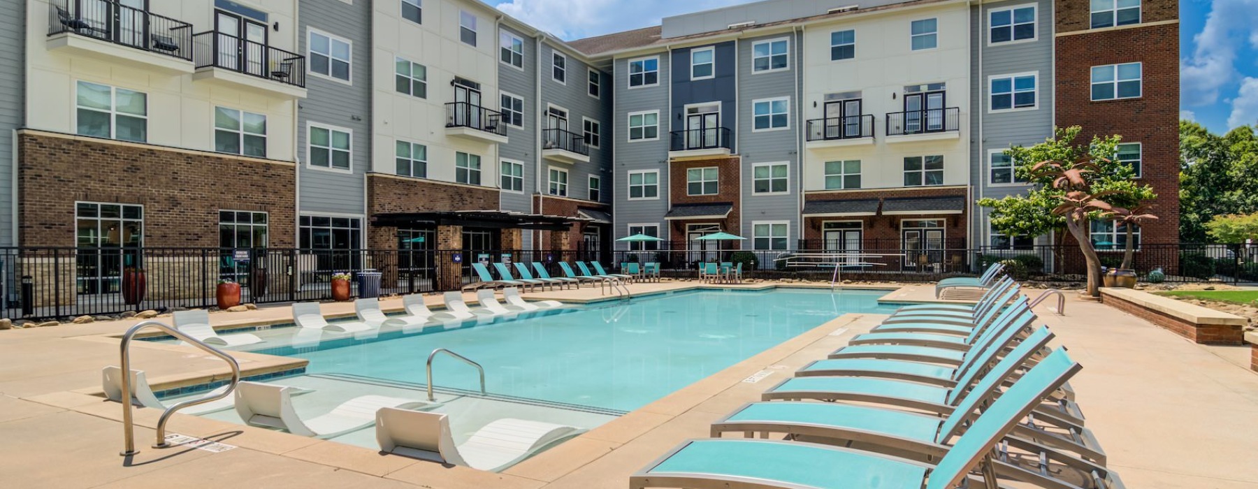 Resort-style swimming pool with lounge seating