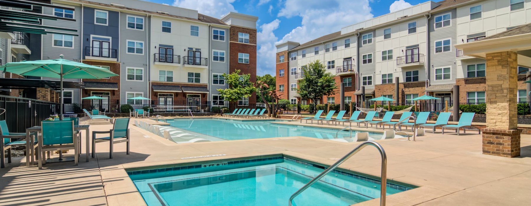 Resort-style swimming pool with lounge seating